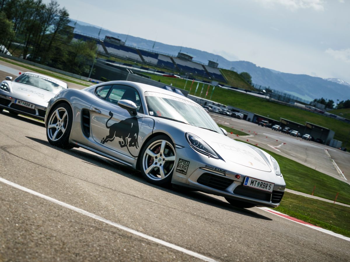 Porsche 718 Cayman S taking the corners of the race track