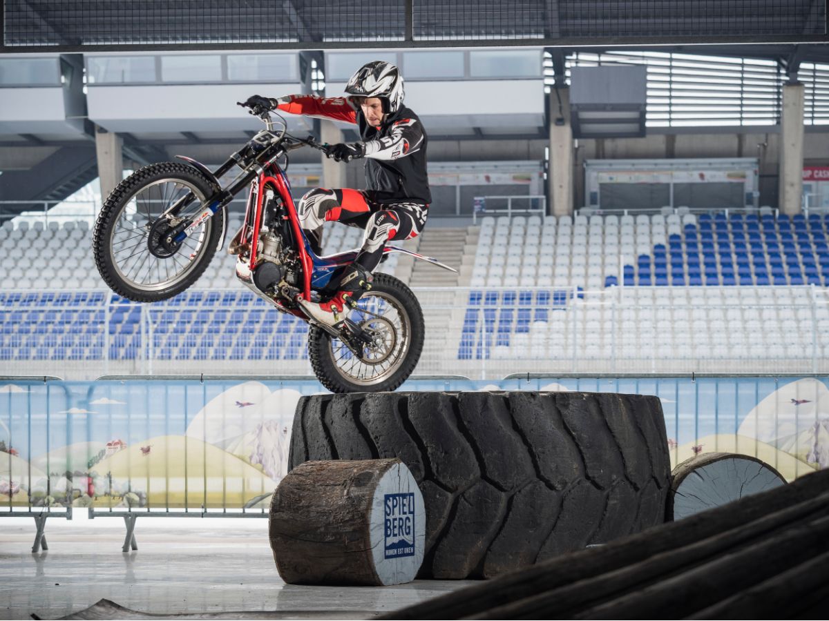 Trial Bike balancing on massive tyre