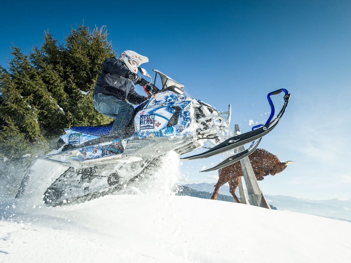 Snowmobil jumping in the snow